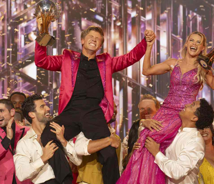 Robert Irwin and Witney Carson celebrate with Mirrorball Trophy at Dancing With the Stars Season 34 finale.