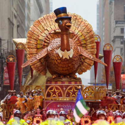 A cozy Thanksgiving dinner table with roast turkey, autumn decorations, and warm candlelight