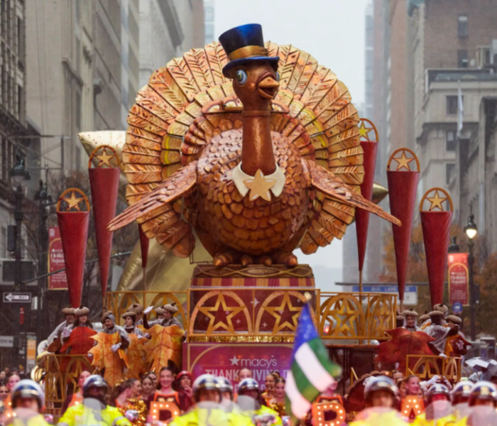 A cozy Thanksgiving dinner table with roast turkey, autumn decorations, and warm candlelight